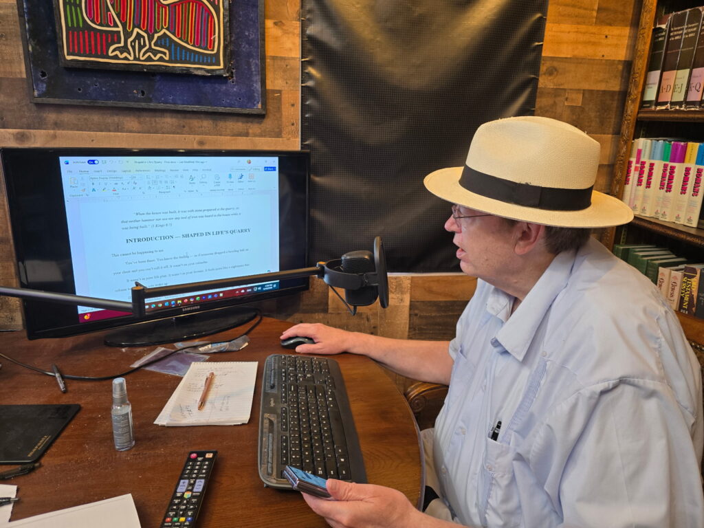 My First Post on Shaped in Life's Quarry Don Cole wearing Panama hat, sitting at desk looking at computer and reading into a microphone