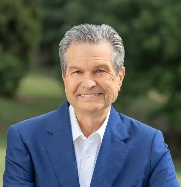Rick Jackson Photo of Rick Jackson wearing white shirt, no tie, blue blazer