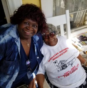 Lucille Shazier Two ladies smiling and sitting together on the porch
